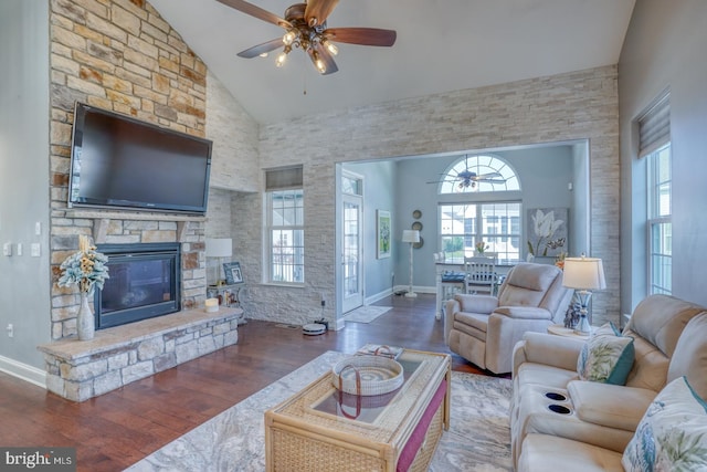 living room with a fireplace, dark hardwood / wood-style floors, high vaulted ceiling, and ceiling fan