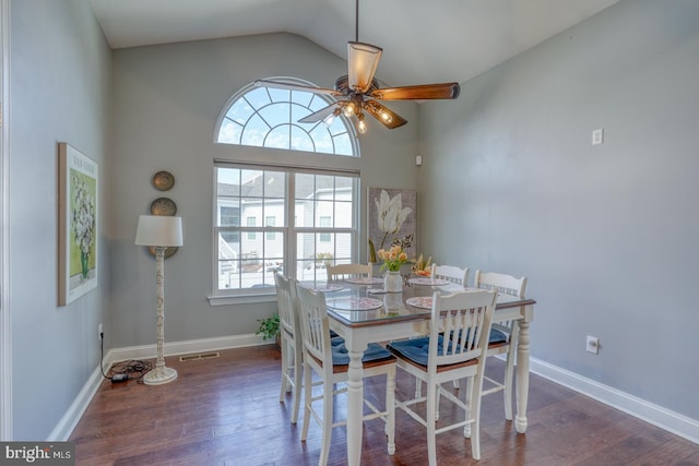 dining room with vaulted ceiling, dark hardwood / wood-style floors, and ceiling fan