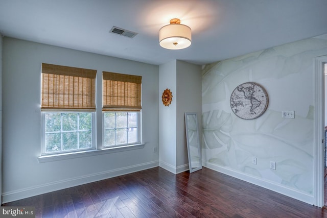 spare room featuring dark hardwood / wood-style flooring