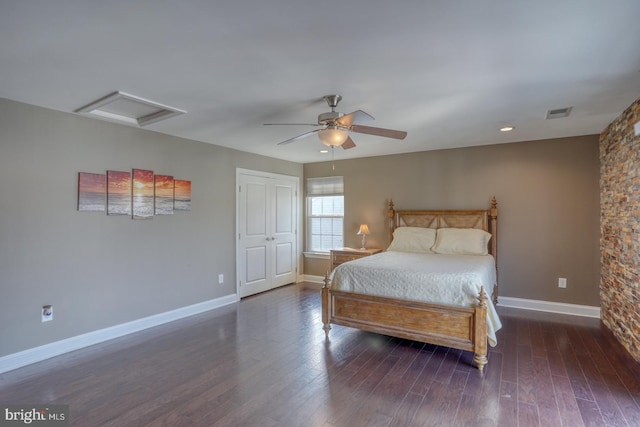 bedroom featuring a closet, dark hardwood / wood-style floors, and ceiling fan