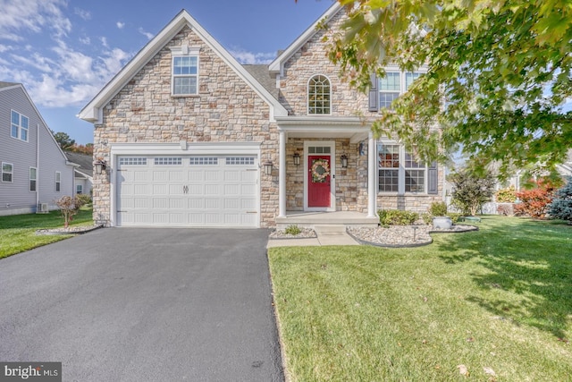 view of front of property with a front lawn and a garage