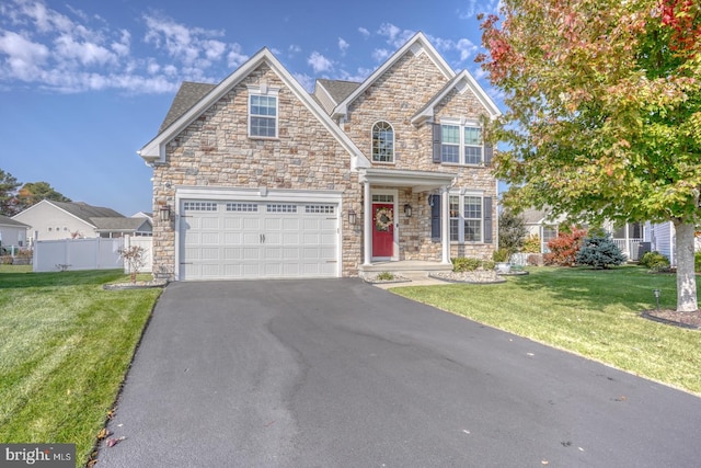 view of front of home with a front yard and a garage