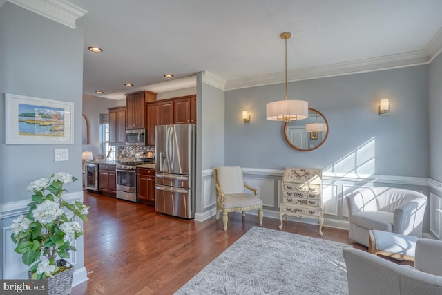 kitchen with tasteful backsplash, dark hardwood / wood-style flooring, hanging light fixtures, stainless steel appliances, and crown molding