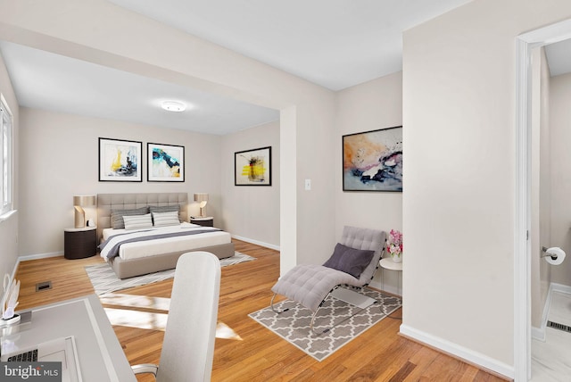 bedroom featuring wood finished floors and baseboards
