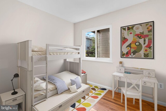 bedroom with wood finished floors and baseboards