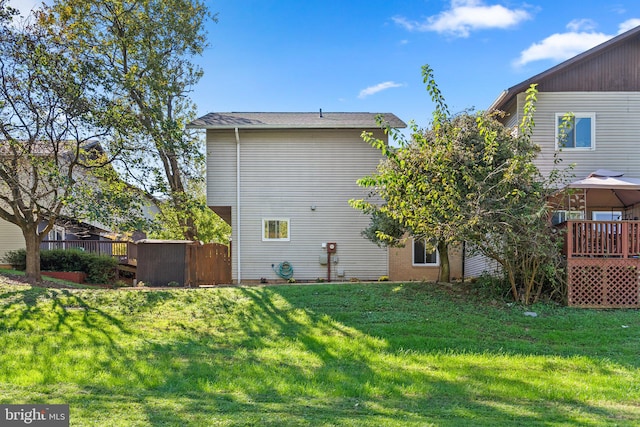 view of home's exterior with a yard and a deck