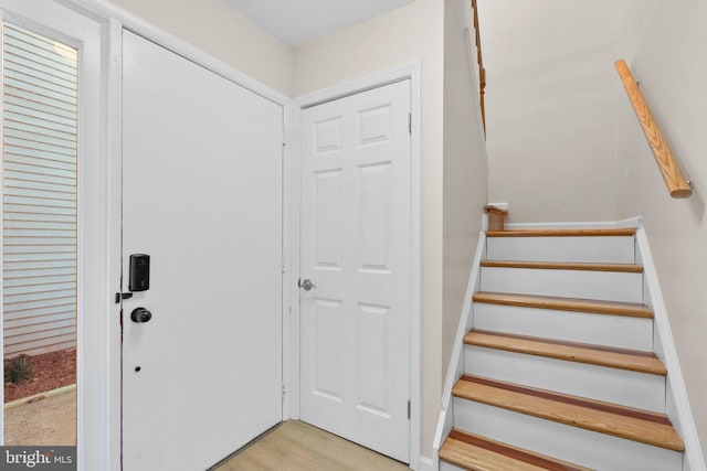 stairs with hardwood / wood-style flooring