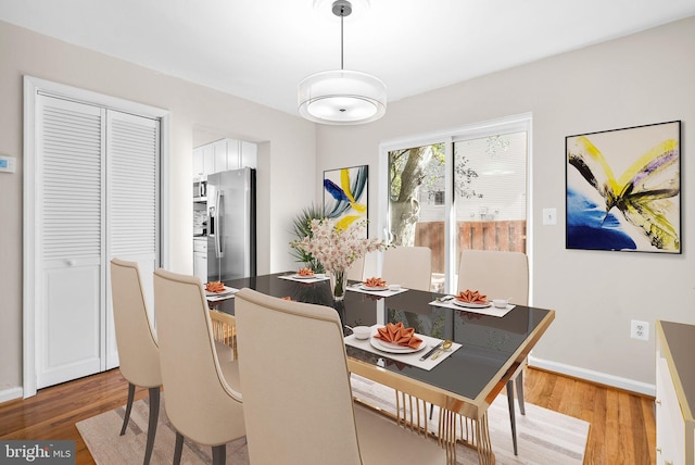 dining space with hardwood / wood-style floors