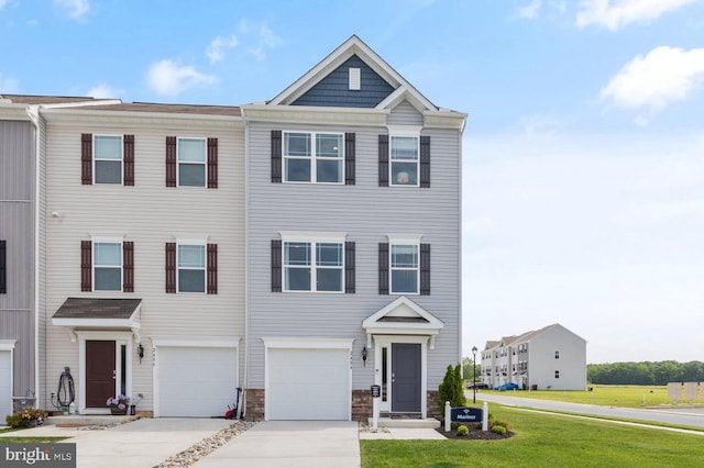 view of property featuring a front lawn and a garage