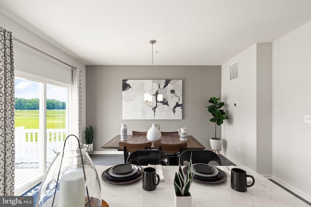 dining area featuring an inviting chandelier