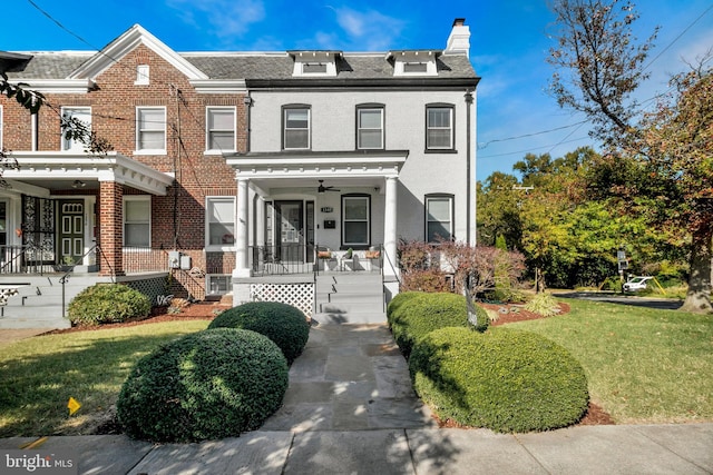 townhome / multi-family property featuring a porch and a front lawn