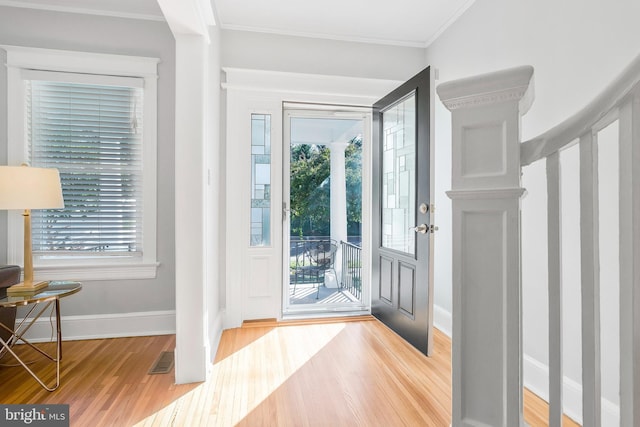 entrance foyer featuring crown molding and hardwood / wood-style flooring