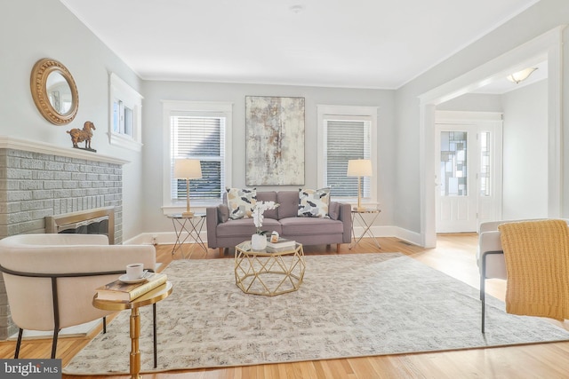 living room with light hardwood / wood-style flooring and a fireplace