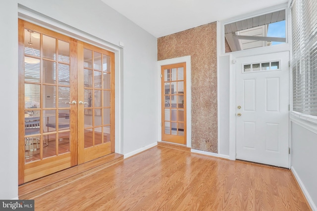 entrance foyer featuring french doors and light hardwood / wood-style flooring