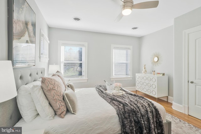 bedroom with hardwood / wood-style floors and ceiling fan