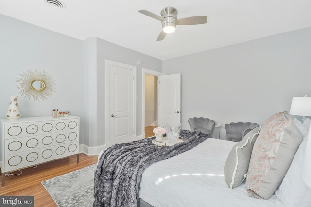 bedroom featuring hardwood / wood-style floors and ceiling fan