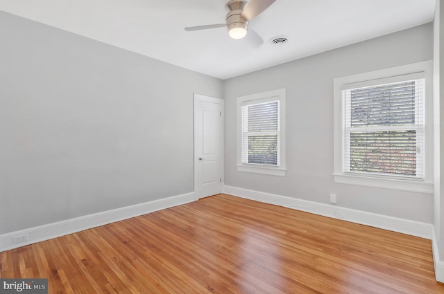 unfurnished room with ceiling fan and light wood-type flooring