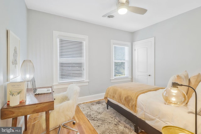 bedroom with ceiling fan and hardwood / wood-style floors