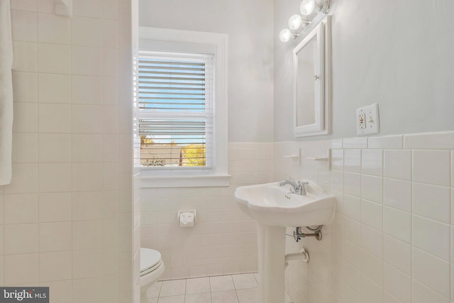 bathroom featuring tile walls, toilet, and tile patterned flooring