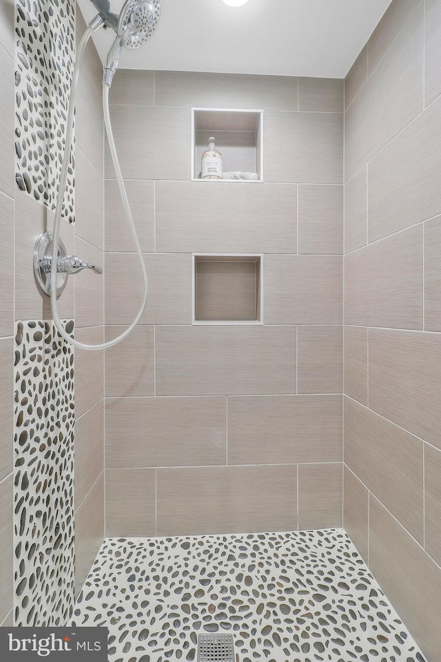 bathroom with tiled shower