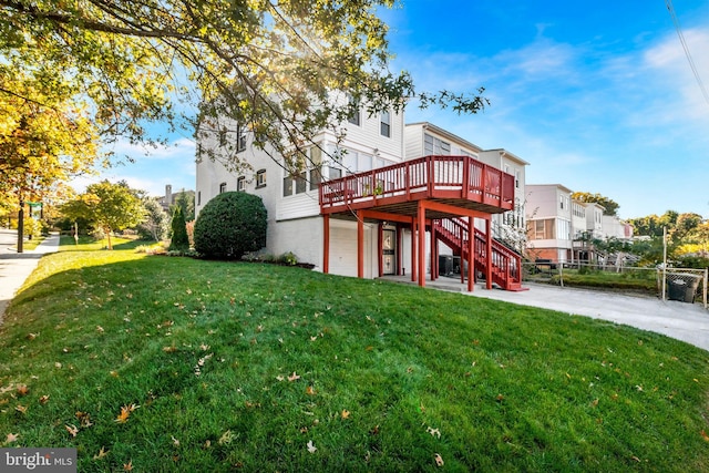 rear view of house with a yard and a deck