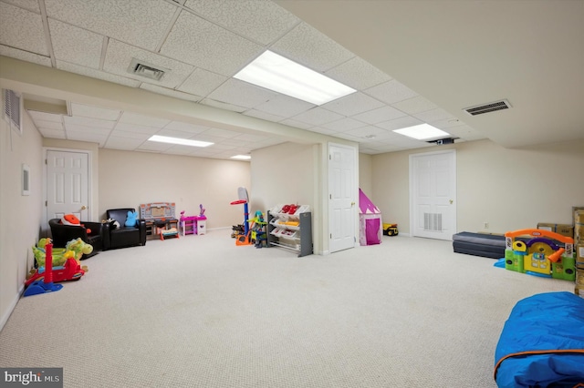 game room with carpet and a drop ceiling