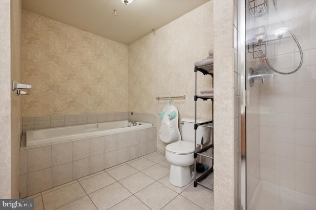 bathroom featuring tile patterned flooring, toilet, and plus walk in shower