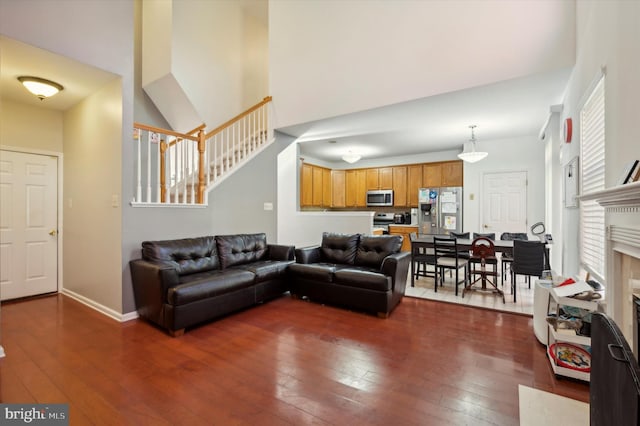 living room with a fireplace and dark wood-type flooring