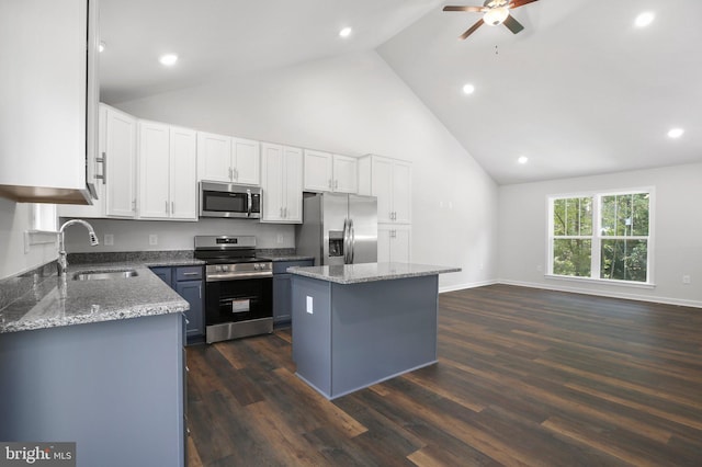 kitchen featuring a kitchen island, sink, white cabinetry, and stainless steel appliances