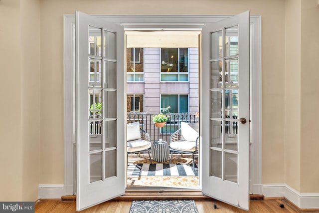 doorway with french doors and wood-type flooring