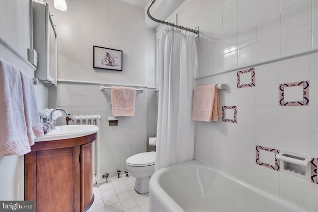 full bathroom with shower / bath combination with curtain, toilet, tile patterned floors, tile walls, and vanity