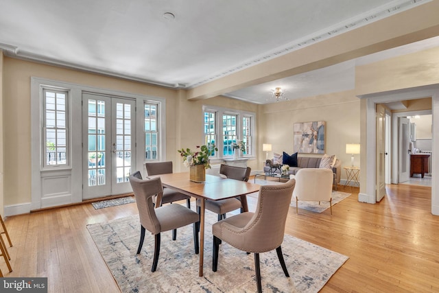 dining space featuring french doors and light hardwood / wood-style flooring