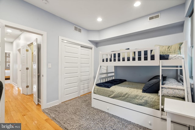 bedroom with a closet and hardwood / wood-style flooring