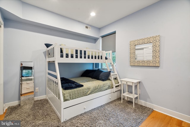 bedroom with hardwood / wood-style flooring