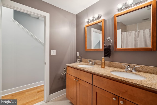 bathroom featuring vanity and wood-type flooring