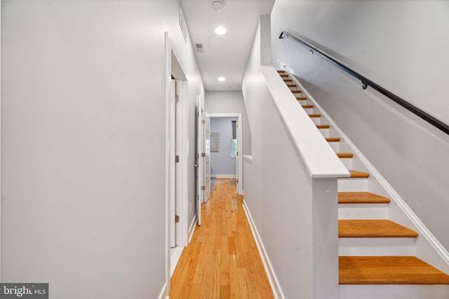 stairway with hardwood / wood-style flooring