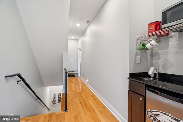 hallway featuring sink and light wood-type flooring