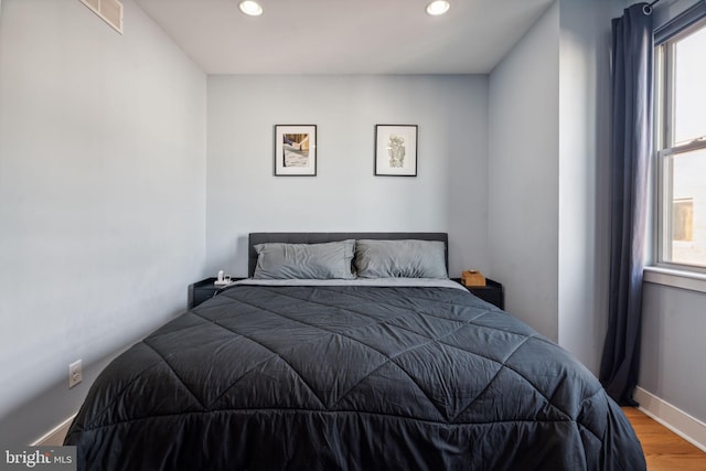 bedroom with hardwood / wood-style flooring