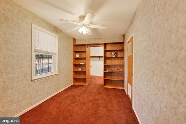 interior space featuring ceiling fan and dark carpet