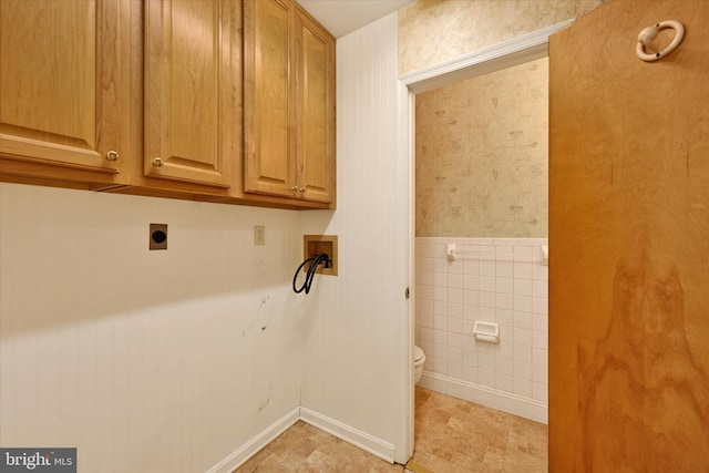 clothes washing area with cabinets, hookup for a washing machine, tile walls, and electric dryer hookup