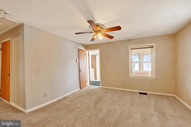 carpeted empty room featuring ceiling fan