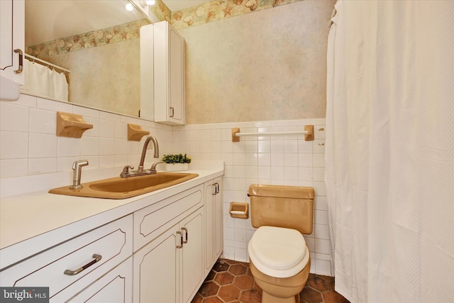 bathroom with tile patterned flooring, vanity, tile walls, and toilet