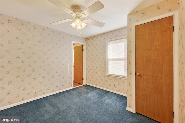 carpeted spare room with ceiling fan