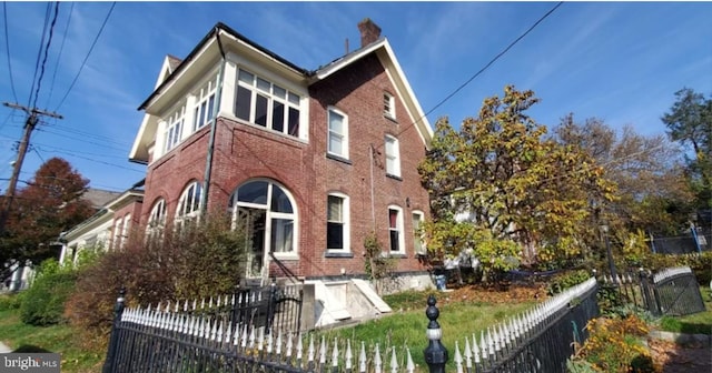 137 S 2nd St, Bangor, PA 18013 - rear view of property with brick siding, fence, and a chimney