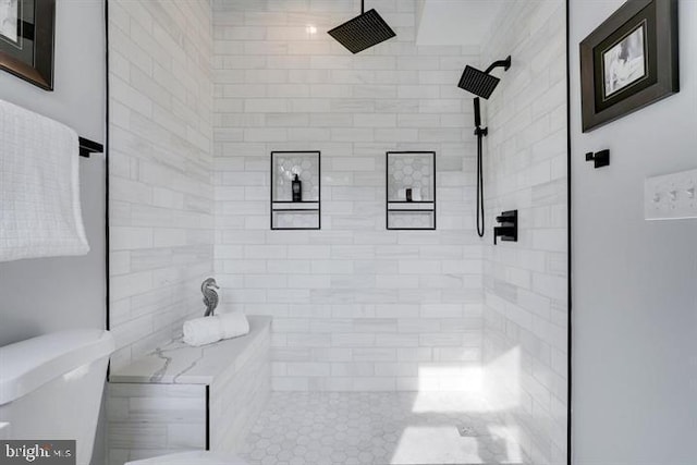 bathroom featuring toilet and a tile shower