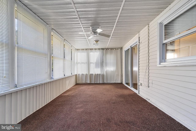 unfurnished sunroom with ceiling fan