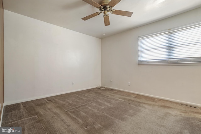 carpeted spare room with ceiling fan