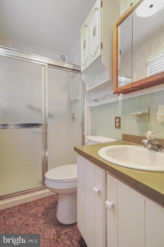 bathroom with vanity, tasteful backsplash, toilet, and an enclosed shower