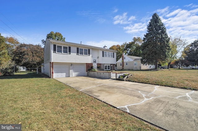 bi-level home with a front lawn and a garage