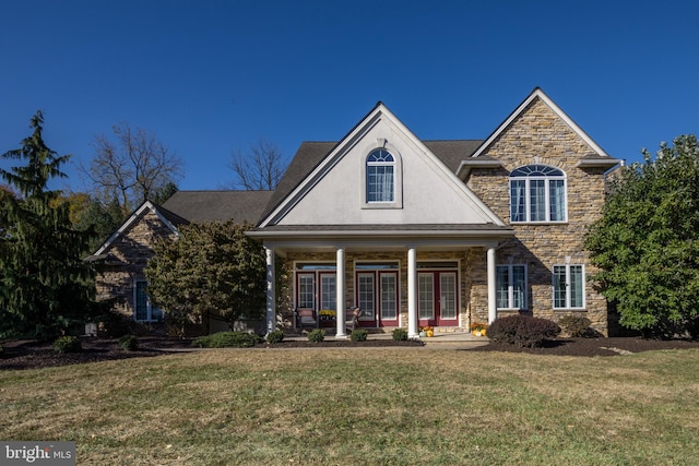 view of front of home with a porch and a front yard